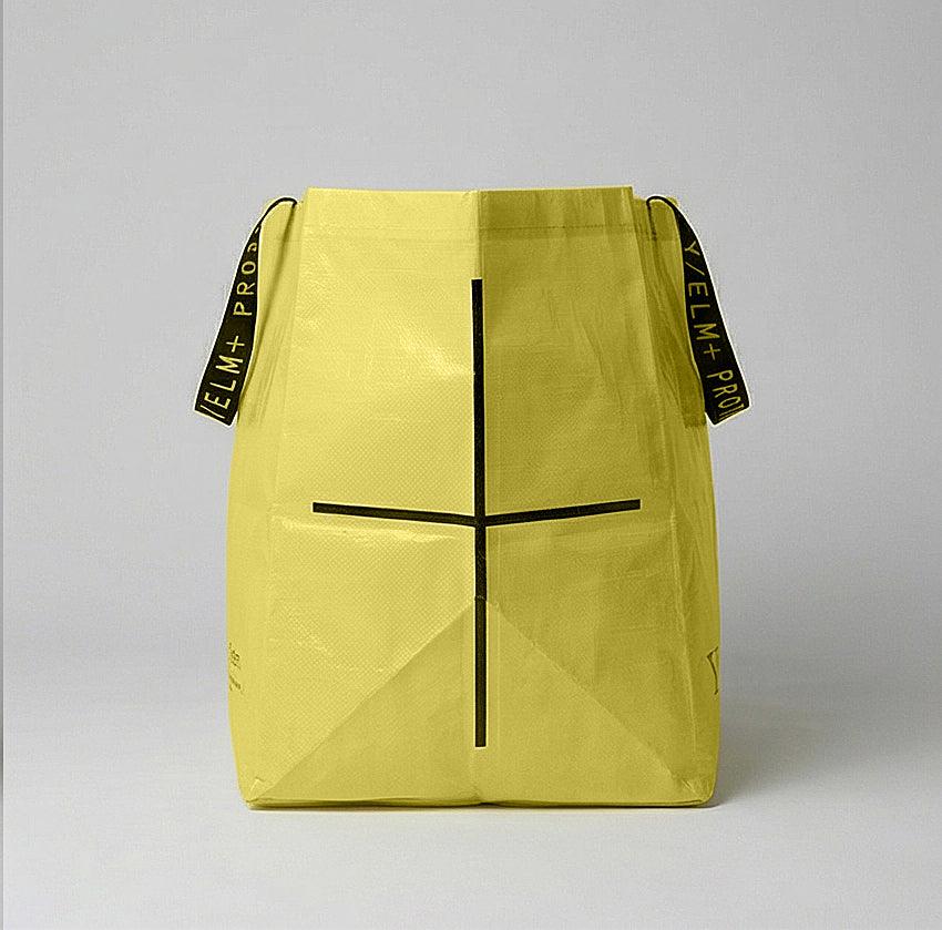 YELM+ haystack drawstring bag with black accents on a gray background